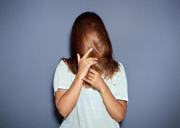 fun-portrait-woman-hiding-behind-her-hair-long-brown-as-pulls-down-over-face-hands-upper-body-over-grey-58773023.jpg